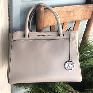 Michael Kors light gray handbag.